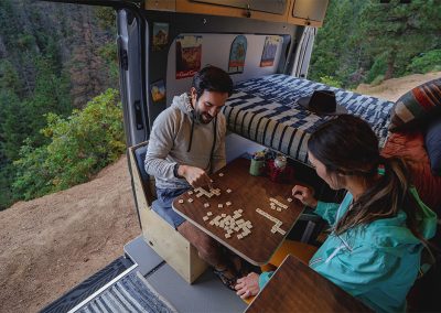 Lagun system in RV, people playing board game on table